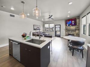 a kitchen with a sink and a table in it at Jordanelle Mountain Paradise 204 condo in Heber City