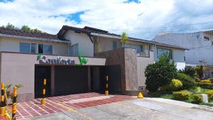 a house with a garage in front of it at Conforta Spa in Popayan