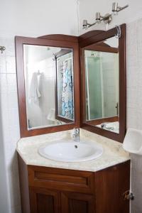a bathroom with a sink and a mirror at Sunny Apartments - ex Zoi Studios in Agioi Apostoli