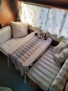 a bed and a couch in a room at Love in the Camper in Florence