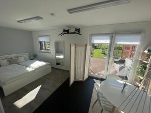 a bedroom with a bed and a table at Le nid de Salsa in Walferdange