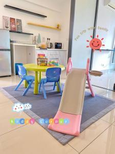 a play room with a table and a play slide at RelaxFamily 2-10Pax Trefoil Setia City Shah Alam SiS Homestay in Shah Alam