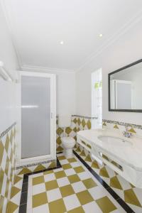 un bagno con vasca, WC e lavandino di Villa Jacaranda ad Albufeira