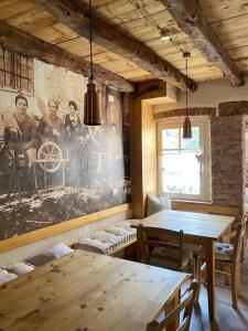 a dining room with two tables and a painting on the wall at Casa del Piol Fattoria dei fiori in Sospirolo