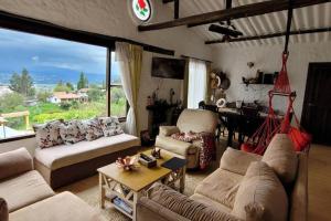 a living room with couches and a table and a dining room at La Rosaleda 1 - Hermosa finca en Paipa in Paipa