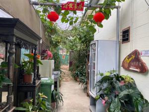 un vicolo con piante e fiori in un edificio di New Famer Hut 2 a Brinchang