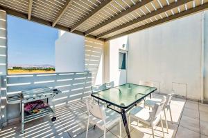 a patio with a glass table and chairs on it at Villa Xenos Tria in Tigaki