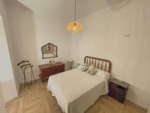 a bedroom with a bed and a dresser and a mirror at El Nido Alojamiento Turístico in Níjar