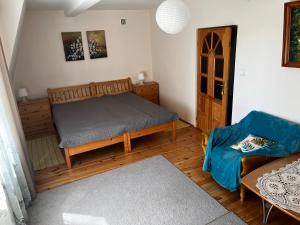 a bedroom with a bed and a wooden floor at Mazury- dom wakacyjny in Pisz