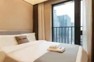 Rúm í herbergi á Livetour Hotel Financial City Keyun Road Metro Guangzhou