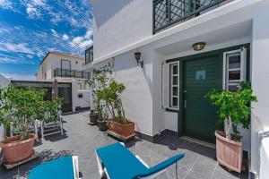patio con sedie blu e porta verde di Ferienhaus mit Meerblick Playa Abades ad Abades