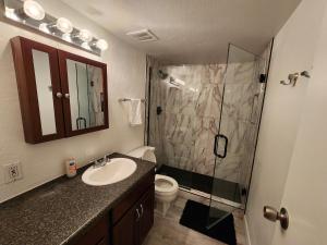 a bathroom with a sink and a glass shower at Lux Resort Condo (Old Town Scottsdale!) in Scottsdale