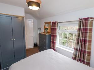 a bedroom with a bed and a window at Riverbank View in Whitby