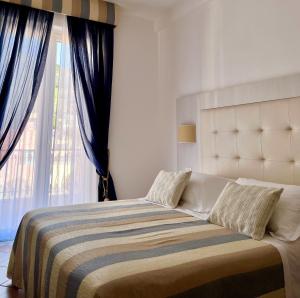 a bedroom with a bed with a large window at Albergo Degli Amici in Monterosso al Mare