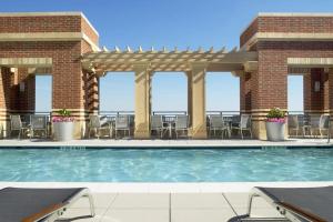 a pool with chairs and tables in a building at Beautiful 1BR Apt At Pentagon City with Great View in Arlington