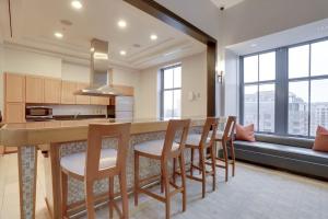 a kitchen with a long wooden table and chairs at Beautiful 1BR Apt At Pentagon City with Great View in Arlington