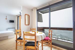 维拉伦贝特Le Point de Vue - Appt pour 4 avec vue的一间有桌子、椅子和窗户的餐厅