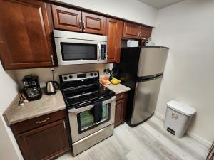 a kitchen with a stainless steel refrigerator and microwave at Lux Resort Condo (Old Town Scottsdale!) in Scottsdale