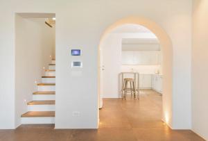 an archway leading to a kitchen and stairs in a house at Casa del Lupo in Platis Gialos