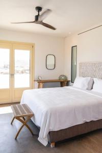 a bedroom with a large white bed and a window at Casa del Lupo in Platis Yialos Mykonos +41 photos