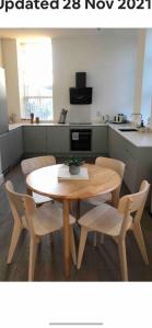a wooden table and chairs in a kitchen with a table at 97a 97b Captains House in Plymouth