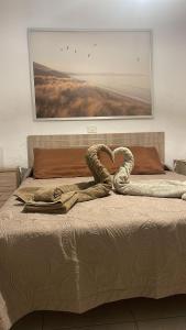 a heart made out of a snake laying on a bed at Casa SolyMar Canarias 6 in Caleta De Fuste