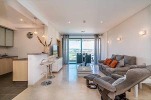 a large living room with a couch and a kitchen at Vilamoura Sun Aquamar 503 in Quarteira