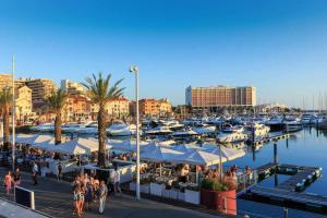 a marina with many boats and people walking around at Vilamoura Sun Aquamar 503 in Quarteira