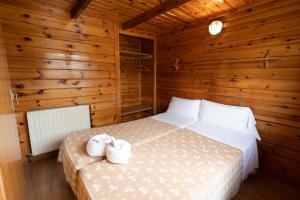 a bedroom with a bed with two towels on it at Vall d'Àger Resort & Camping in Àger