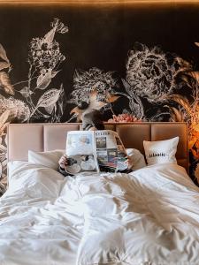 a person laying in bed reading a book at Hotel Atlantic in Westerland (Sylt)