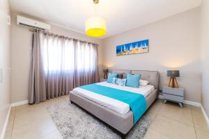 a bedroom with a large bed and a window at Beachcove in Pereybere