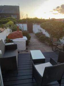 a patio with tables and chairs and a sunset at Fabulous terrace cottage in Blackpool