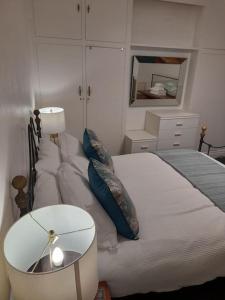 a bedroom with a bed and a table and a mirror at Fabulous terrace cottage in Blackpool