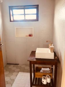 uma casa de banho com lavatório e algum papel higiénico em Casa em Alto Paraíso com vista para as montanhas no Eldorado ao lado do centro em Alto Paraíso de Goiás
