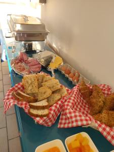 a table topped with a buffet of food with bread and eggs at Cheverny la vie est belle in Cheverny