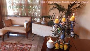 a living room with a table with a plant and candles at B&B Il Giardino di Paola in Alliste