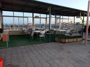 a patio with tables and chairs on a roof at Rew Apartment in Nairobi