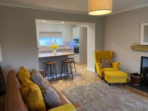 a living room with a couch and a kitchen at Croft@42 in Vatsker