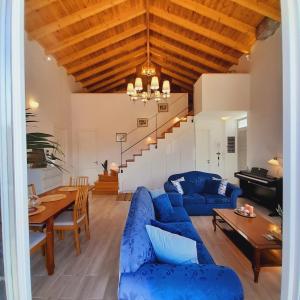 a living room with a blue couch and a table at Tatiana's House in Spetses