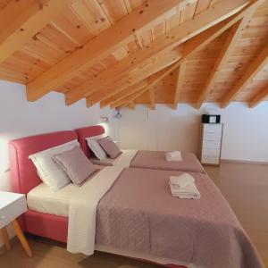 a bedroom with two beds and a red couch at Tatiana's House in Spetses