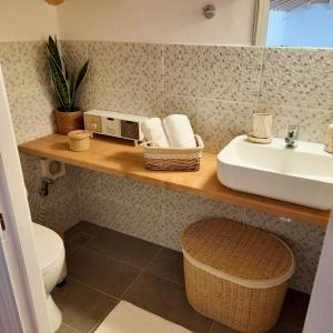 a bathroom with a sink and a toilet at Tatiana's House in Spetses +38 photos