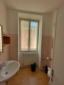 a bathroom with a sink and a window at Albergo Gargnano in Gargnano