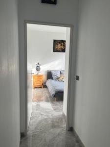 an open door to a bedroom with a bed at Chambre double -vue sur jardin in Bergerac