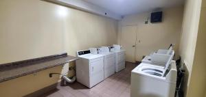 a bathroom with three washing machines and a washer and dryer at Motel 6 Savannah, GA - Gateway & I-95 in Savannah