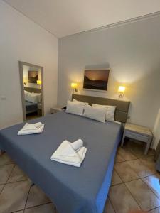 Postel nebo postele na pokoji v ubytování Aristea Hotel