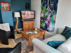 a living room with a couch and a coffee table at 360 degrés sur la rochelle in La Rochelle