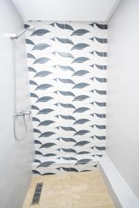 a shower in a bathroom with a wave pattern on the wall at King loubnane in Marrakesh