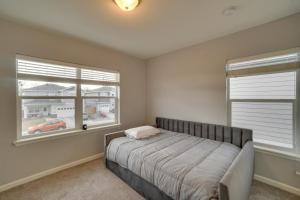 a bedroom with a bed and two windows at Suburban Denver Home with Fire Pit and Shuffleboard! in Denver