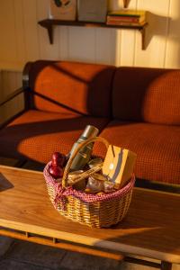 a basket of items on a table in front of a couch at Eastwind Hotel Lake Placid in Lake Placid