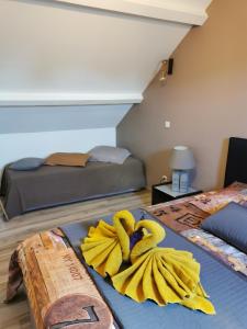 a room with two beds with yellow towels on the floor at Normandie, mer et campagne in Ver-sur-Mer